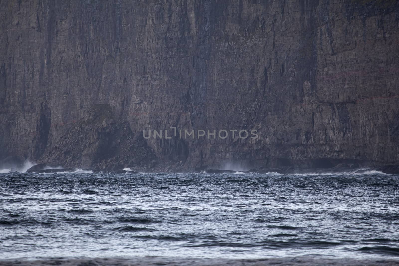 Landscape showing sea waves crushing against the cliff, Faroe Islands