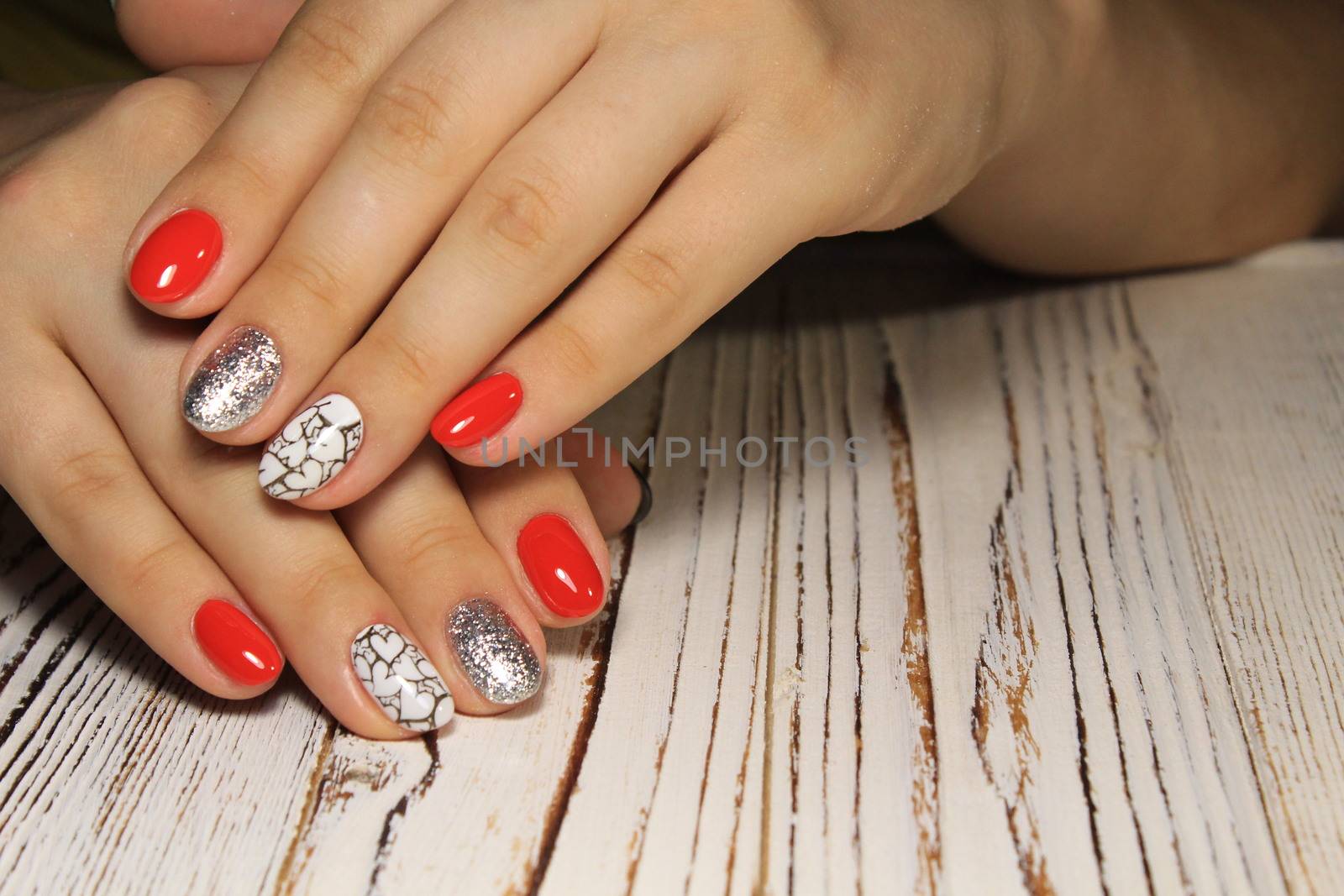 Manicured nails colored with red nail polish by SmirMaxStock