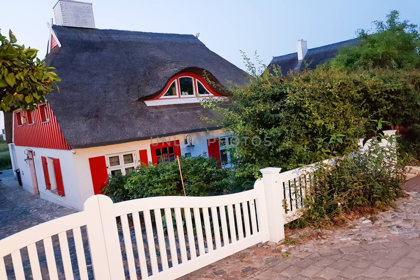 Traditional thatched roof house on a sunny summer day at the baltic sea near the island Ruegen, Germany.