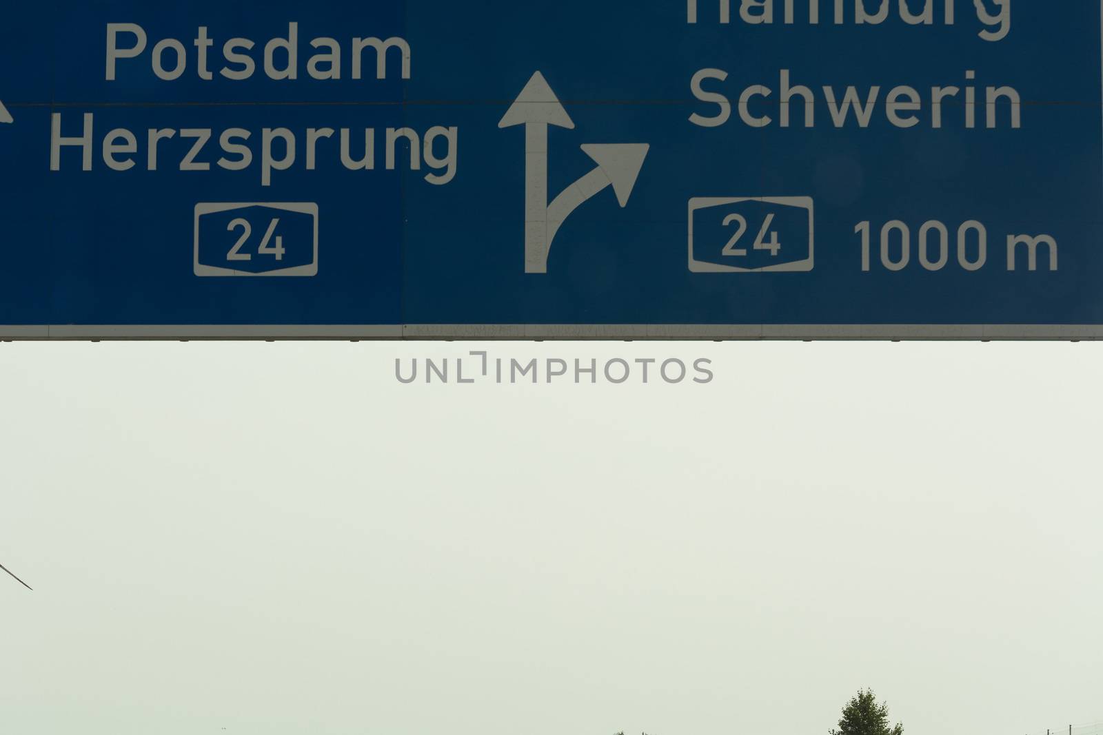 German motorway sign with inscription in German direction arrow to the cities - Berlin, Potsdam, Herzsprung, Hamburg and Schwerin