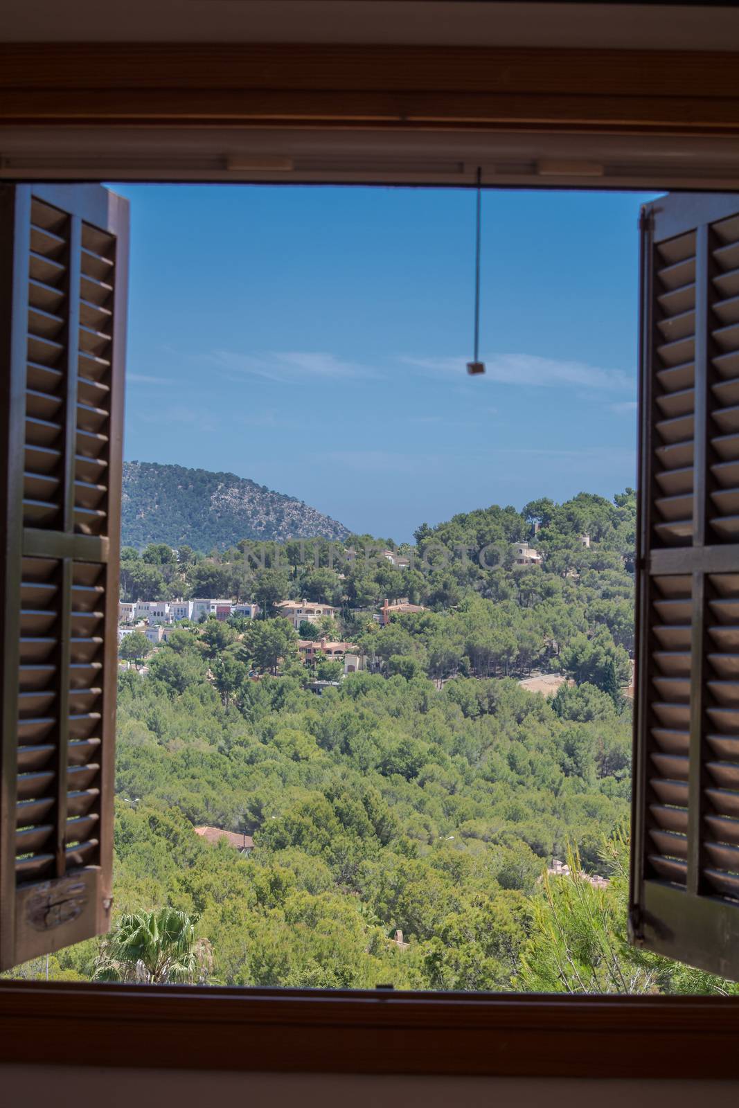 Landscape Houses and mountains seen through the window.