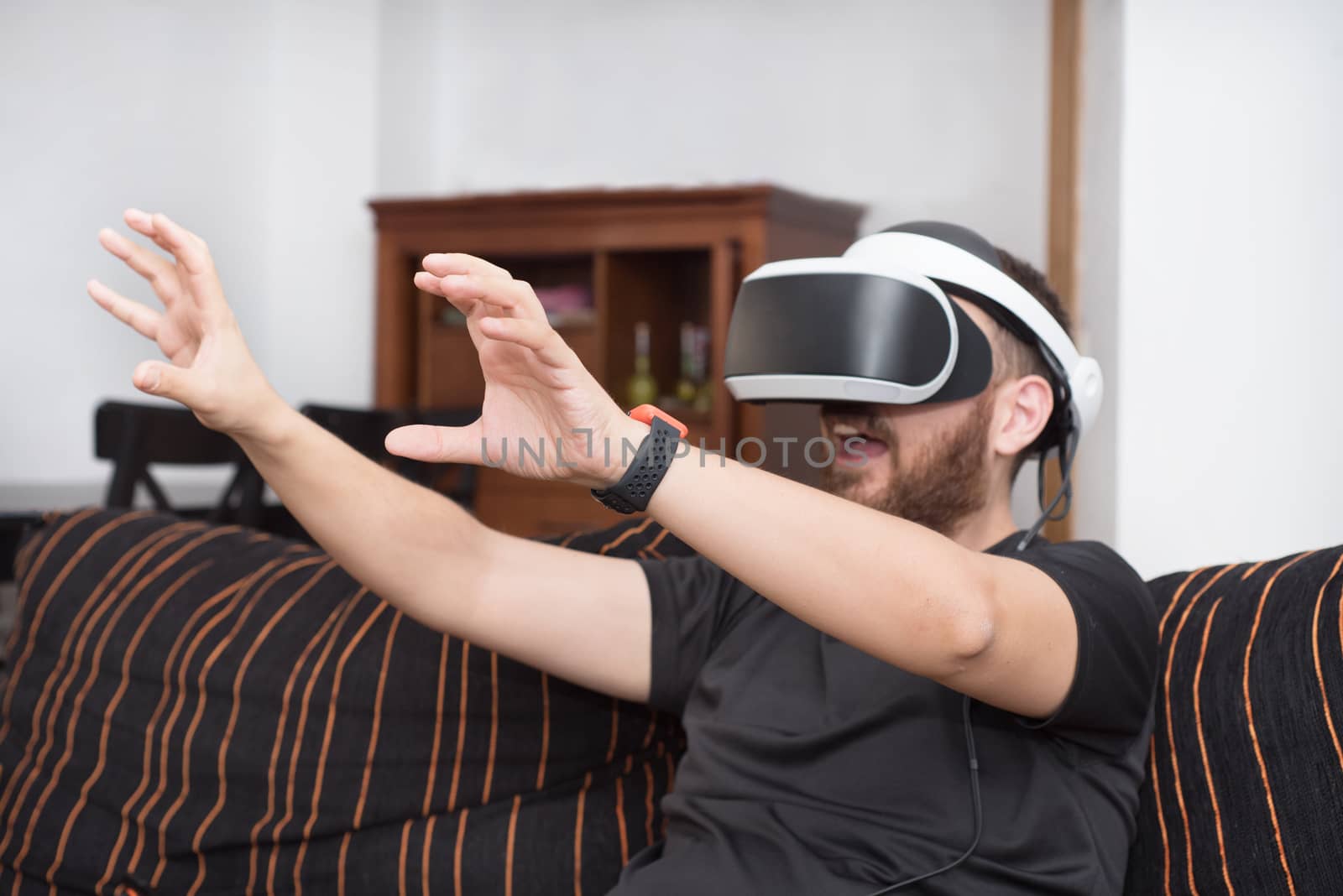 Bearded man wearing virtual reality goggles