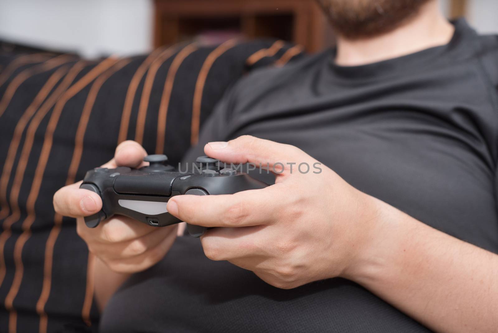 Young man playing video games by HERRAEZ