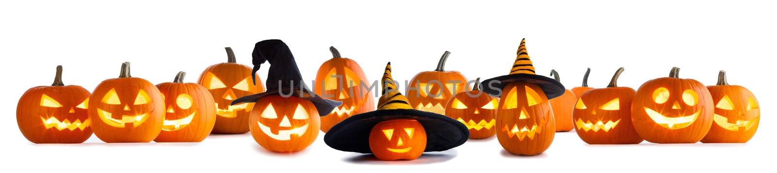 Big collection of Jack O Lantern Halloween pumpkins with various different designs and witches hat in a row isolated on white background