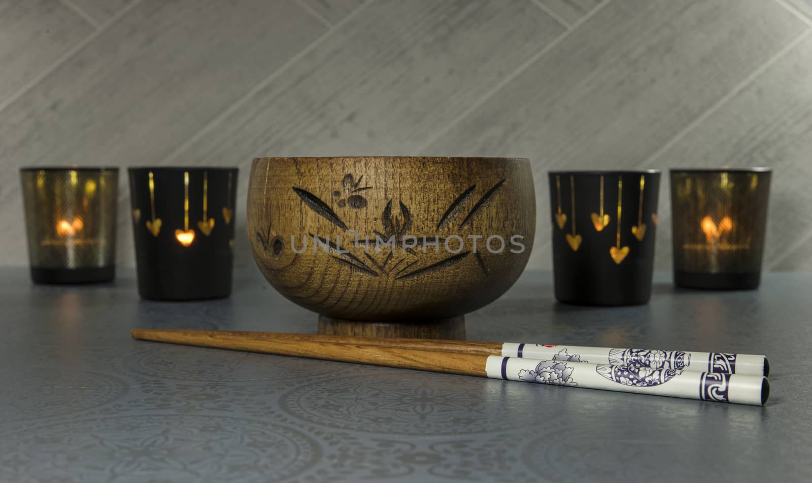 japanese or chines chopsticks with bamboo wooden rice bowl and light at the background