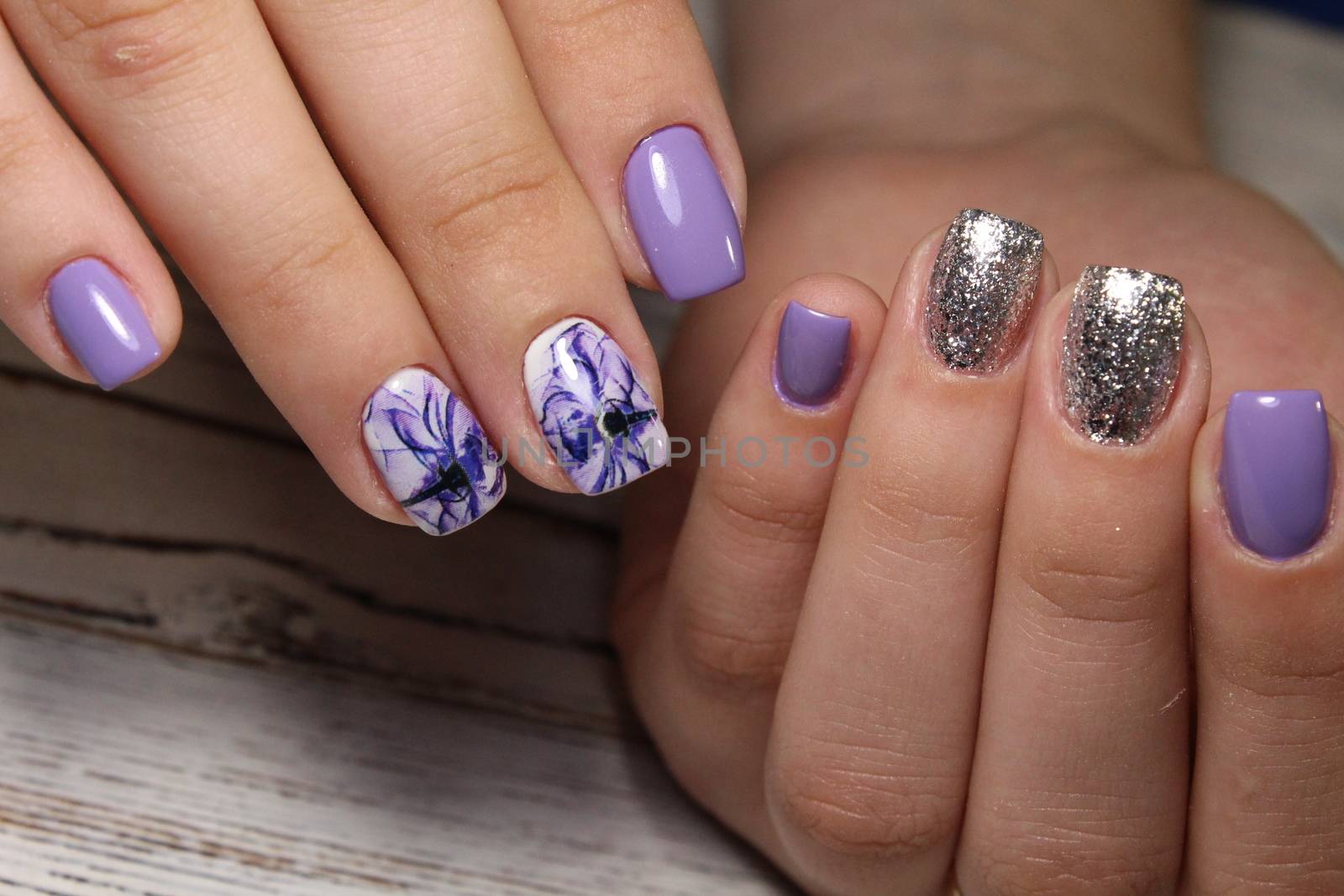 beautiful gray shiny manicure on a trendy texture background