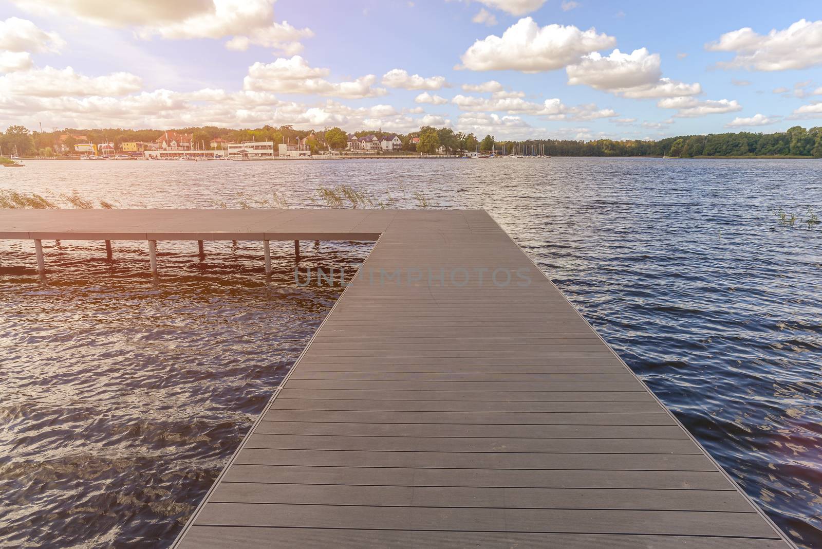 Empty dock in calm lake by RobertChlopas