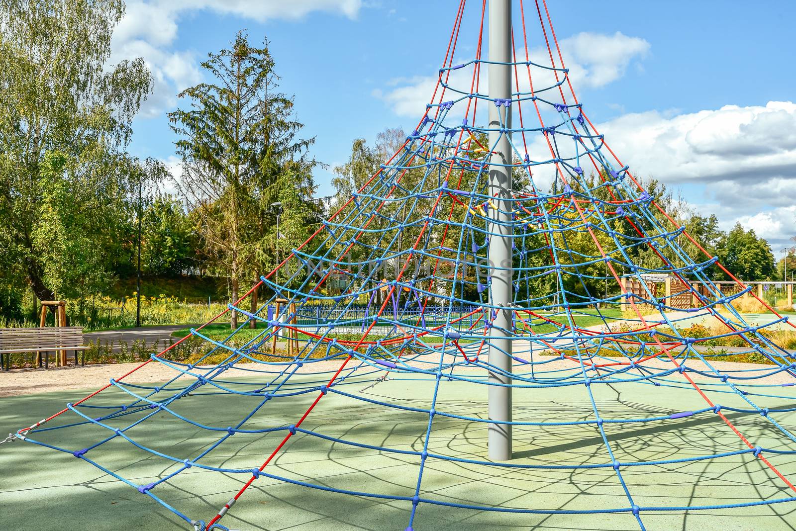 Jungle gym exercise equipment made of metal and ropes in a playground