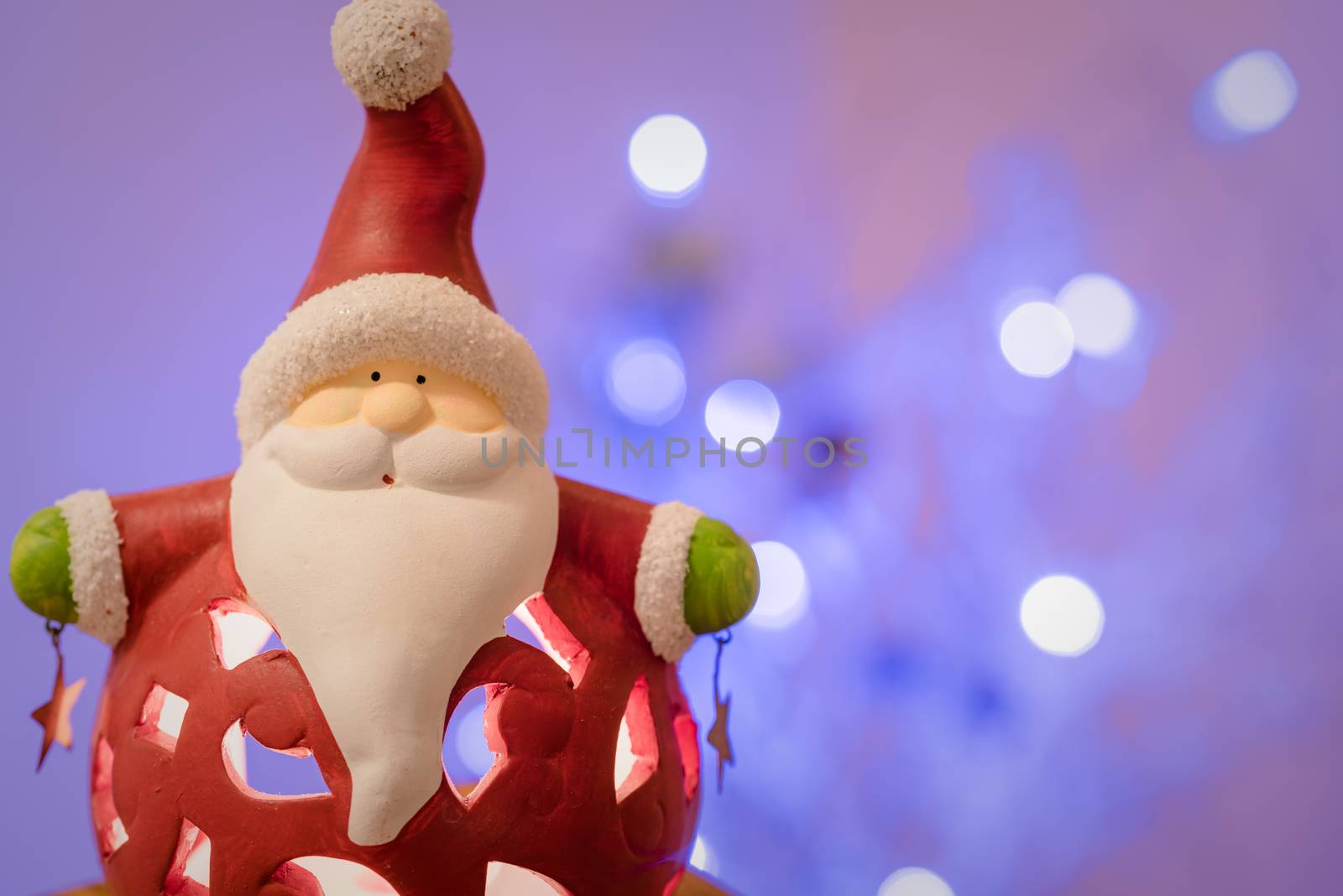 Christmas decoration, porcelain Santa Claus against blur background, focus on Santa.