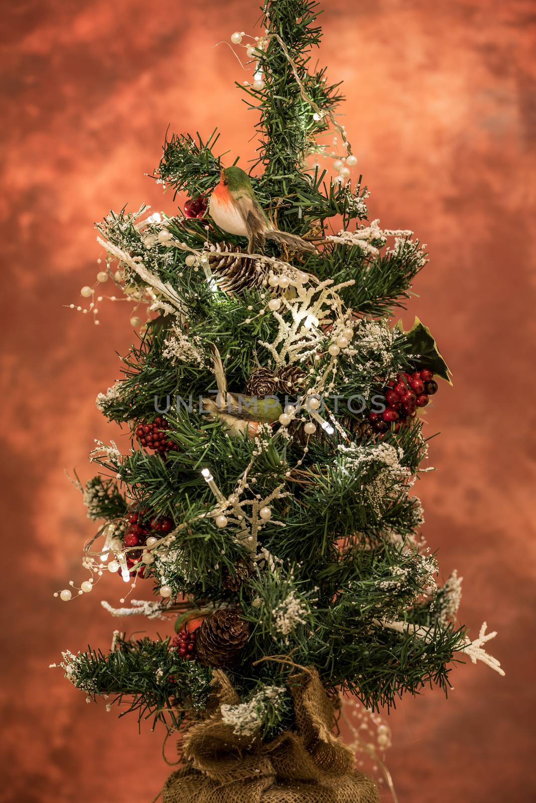 Christmas decoration hanging on a tree covered with snow. Focus on a decoration. Christmas tree.