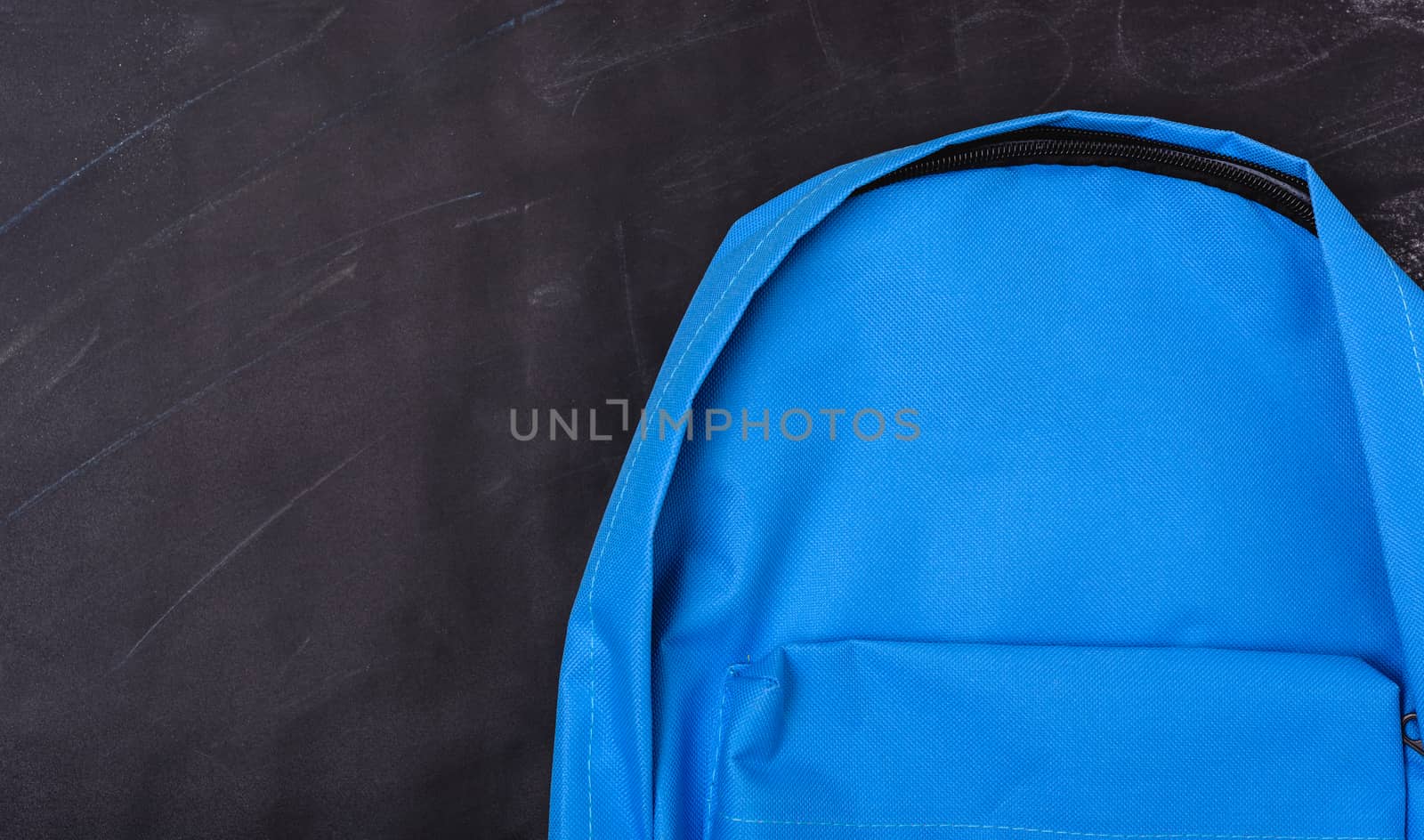 Back to school shopping pocket backpack on the education blue bag on blackboard and chalkboard