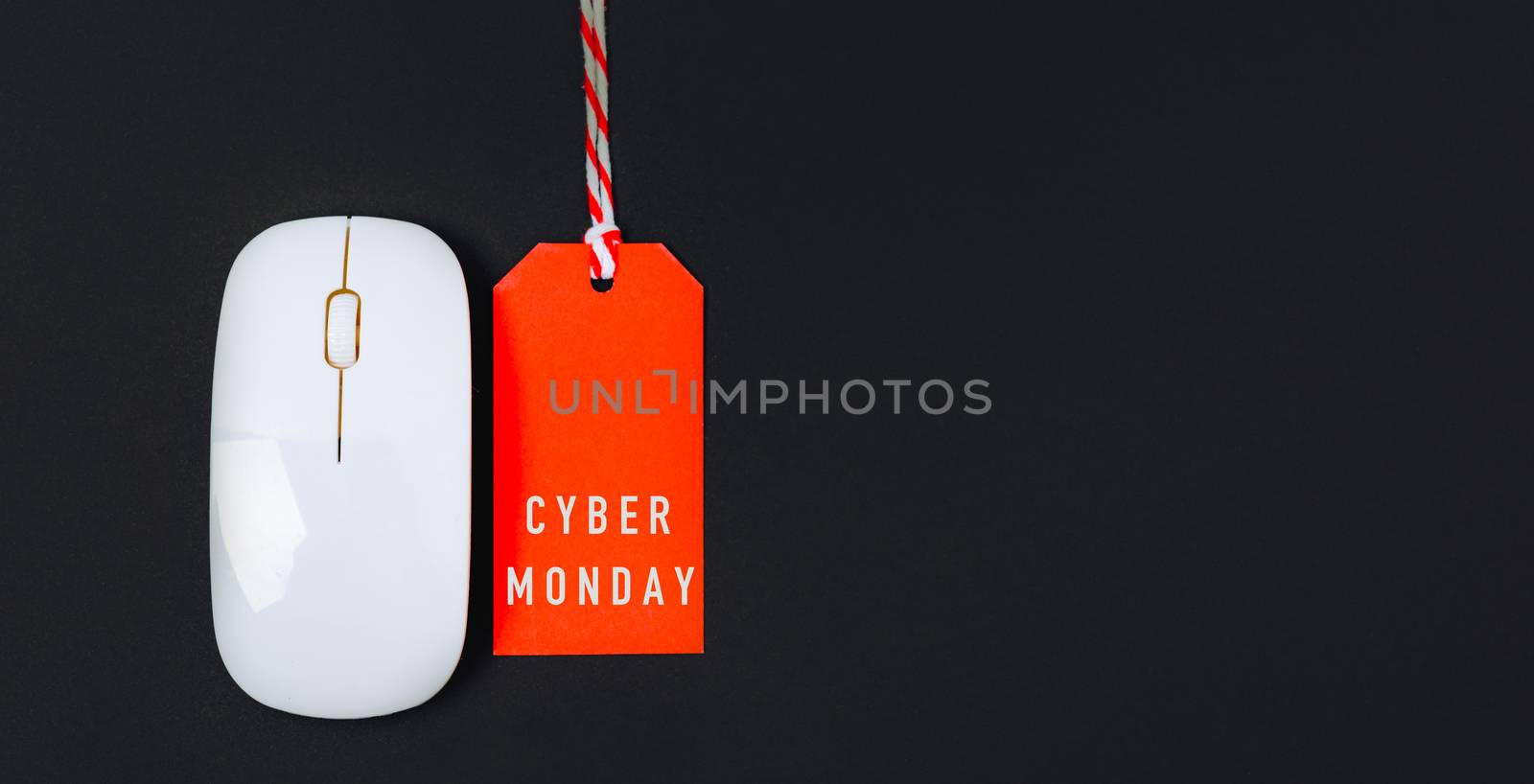 Online shopping Cyber Monday sale text on red tag label and white mouse, with copy space on black background
