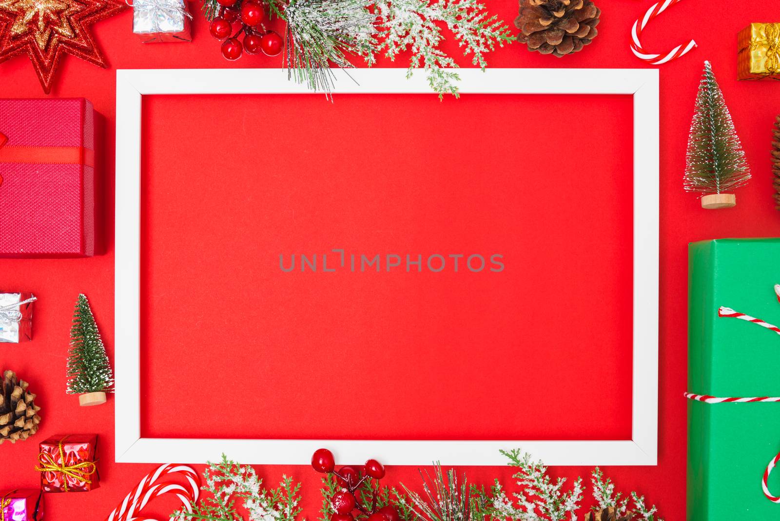 Christmas composition decorations, fir tree branches with Photo square frame on red background. Merry Christmas concept. Copy space for text