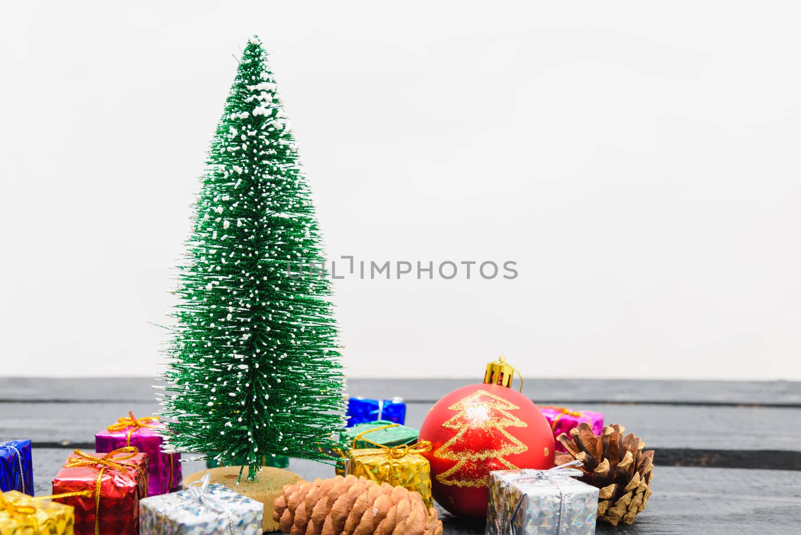 Christmas composition decorations, minimal green fir tree branches with snow and gift boxs on white background. Merry Christmas concept. Copy space for text