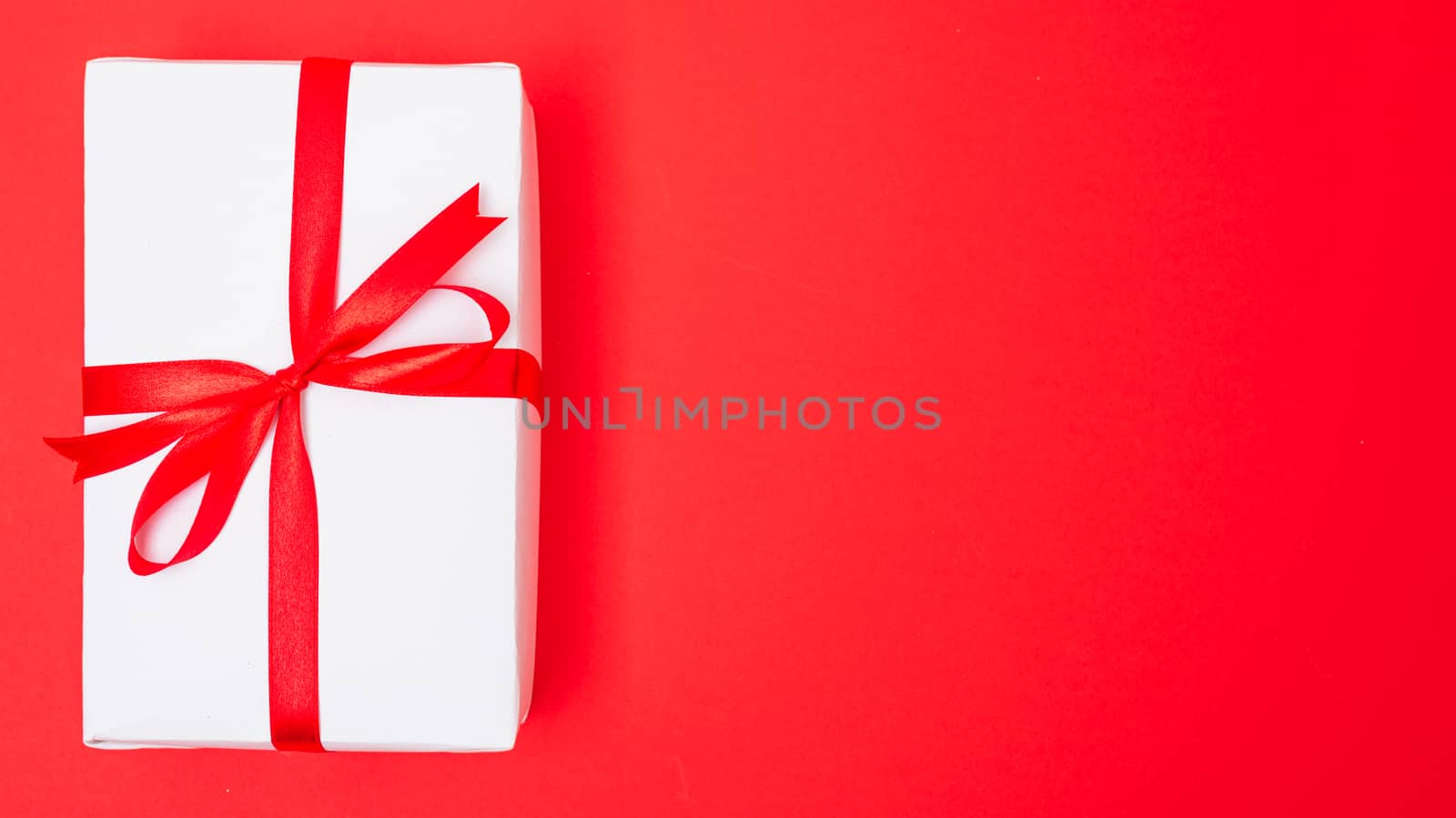 Happy New Year and Christmas 2020 or valentine day, top view Xmas white gift box on red background with copy space for your text