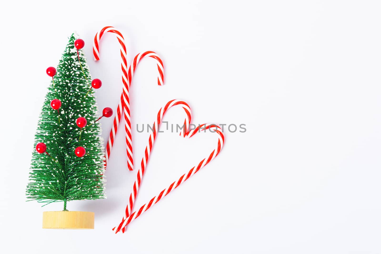 Happy New Year and Christmas day, top view flat lay composition decoration have branch tree and candy on white background with copy space for your text