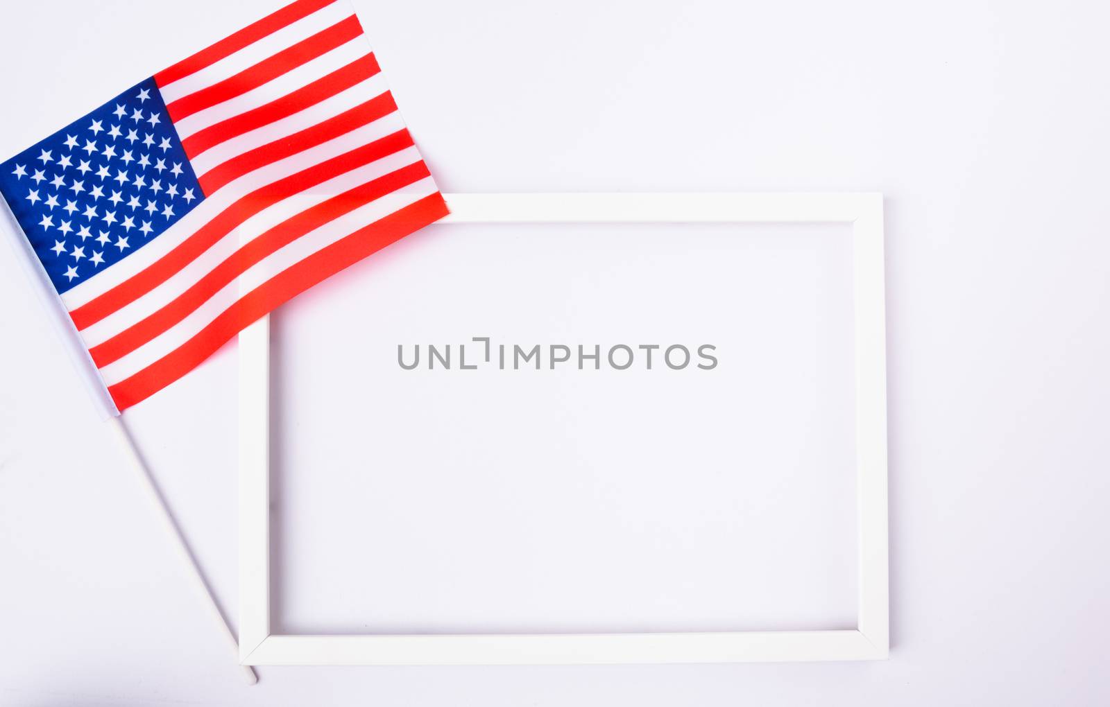Martin luther king day, flat lay top view, American flag and photo frame on white background with copy space for your text