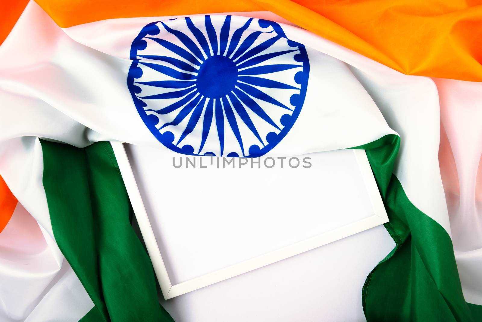 Indian republic day, flat lay top view, Indian tricolor flag and photo frame on white background with copy space for your text