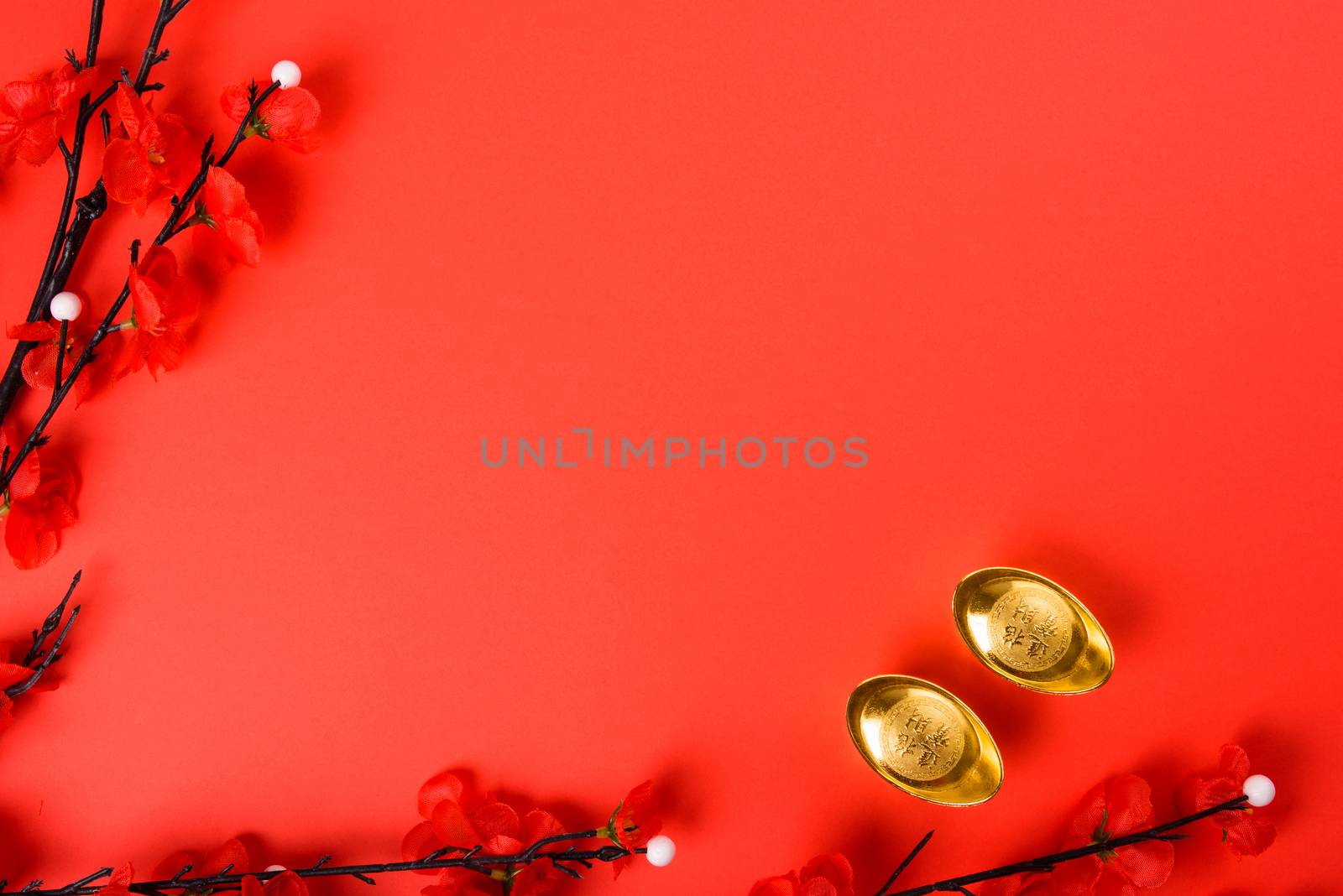 Chinese New Year, flat lay top view, gold bar and Chinese Flower on red background with copy space for your text