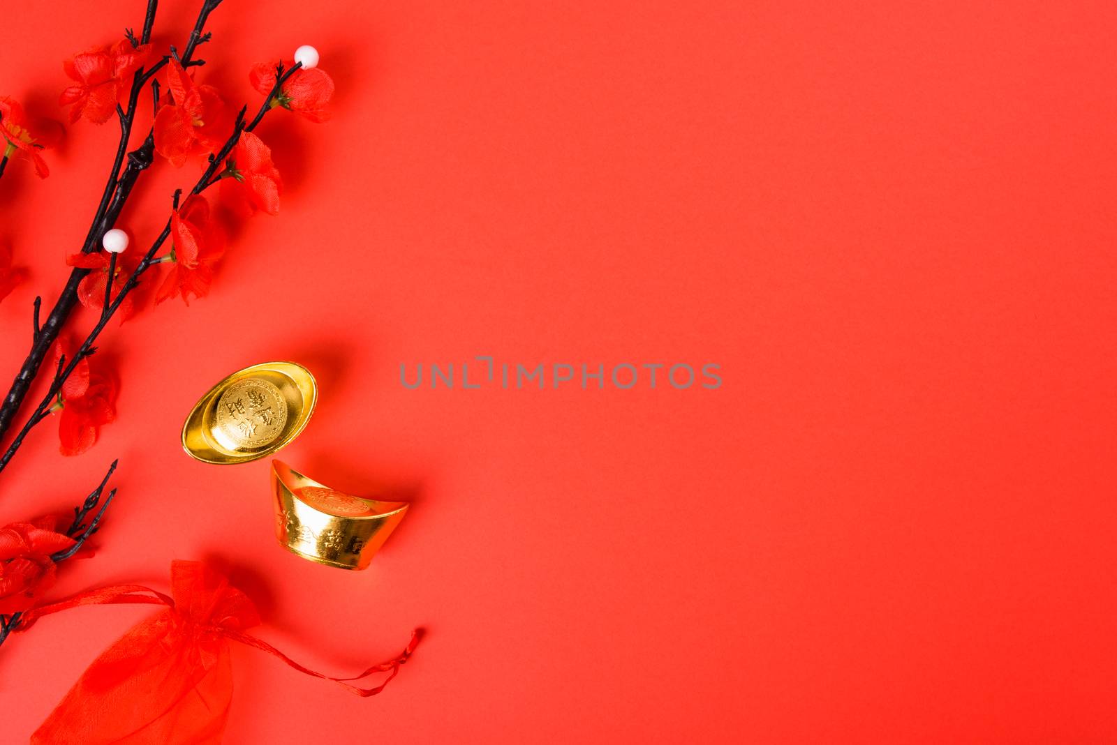 Chinese New Year, flat lay top view, gold bar and Chinese Flower on red background with copy space for your text