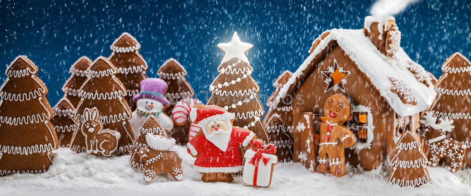 Gingerbread house christmas fir trees Santa Claus and gift cookies winter holiday celebration concept