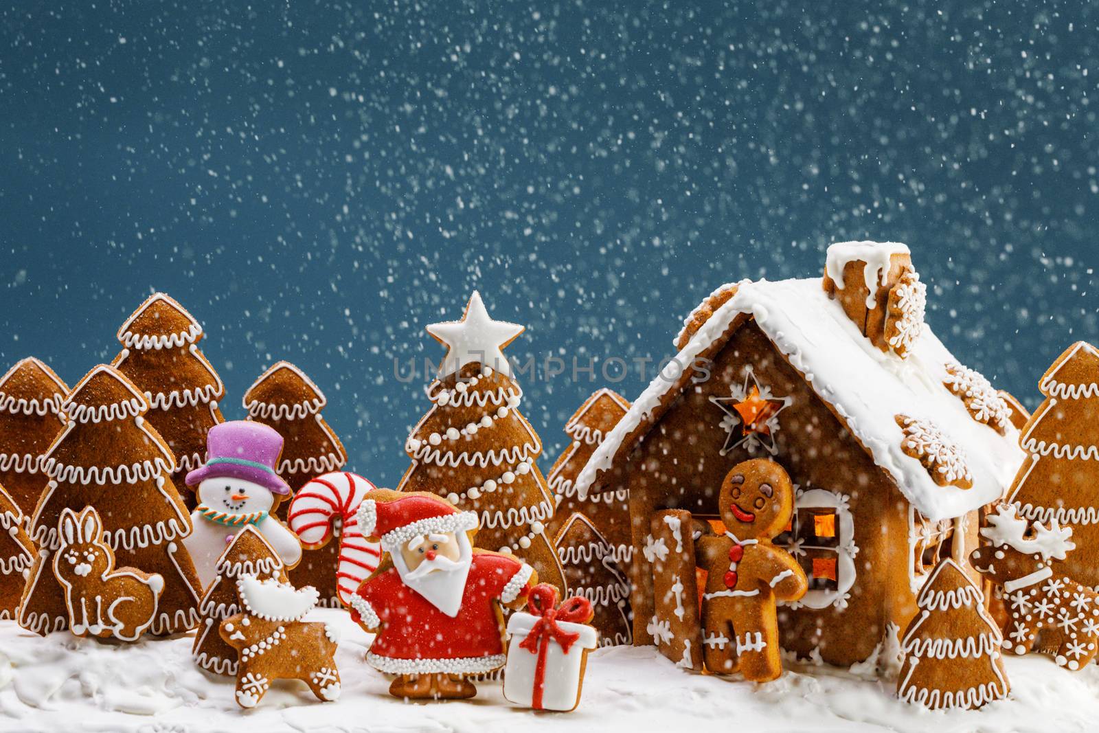 Gingerbread house christmas fir trees Santa Claus and gift cookies winter holiday celebration concept