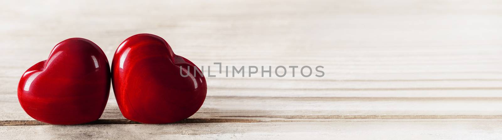Two red wooden hearts symbol of love on wooden background, Saint Valentine Day celebration, copy space for text