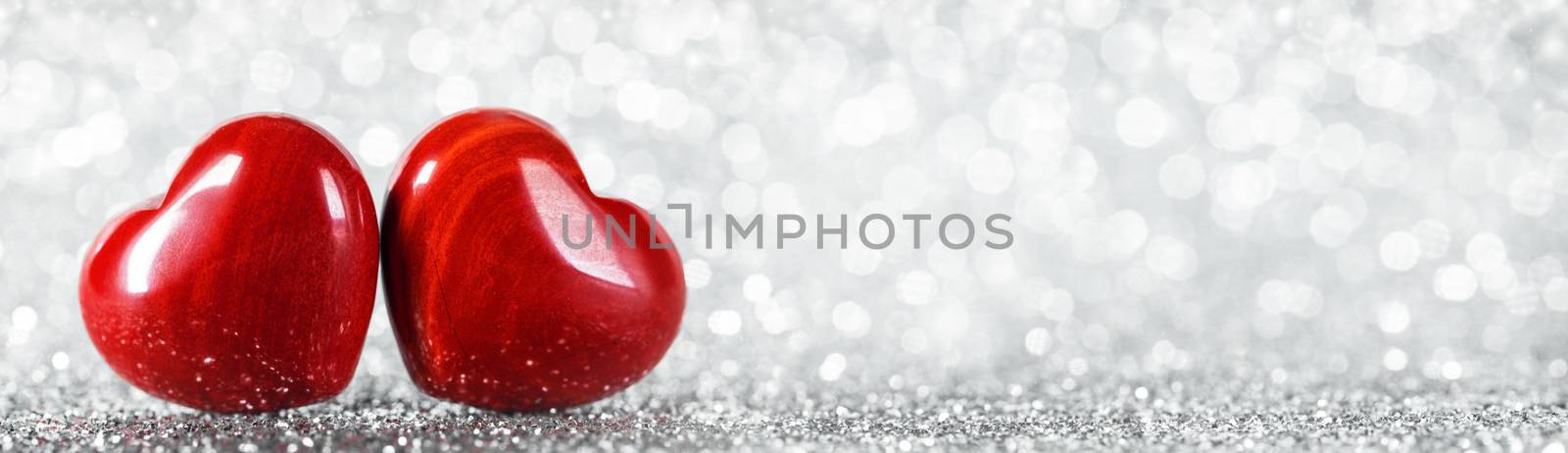 Two red wooden hearts symbol of love on background with beautiful bokeh, Saint Valentine Day celebration, copy space for text