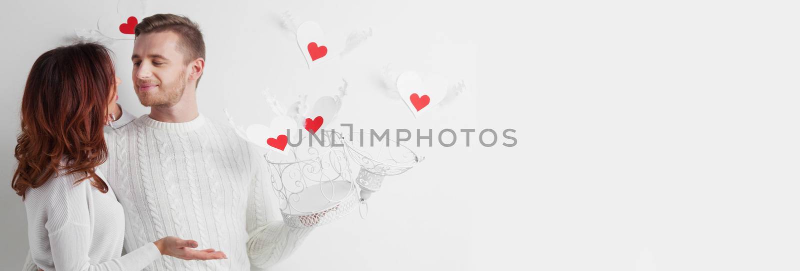 Couple releasing love concept, man and woman open cage with winged hearts, valentines day white and red colors