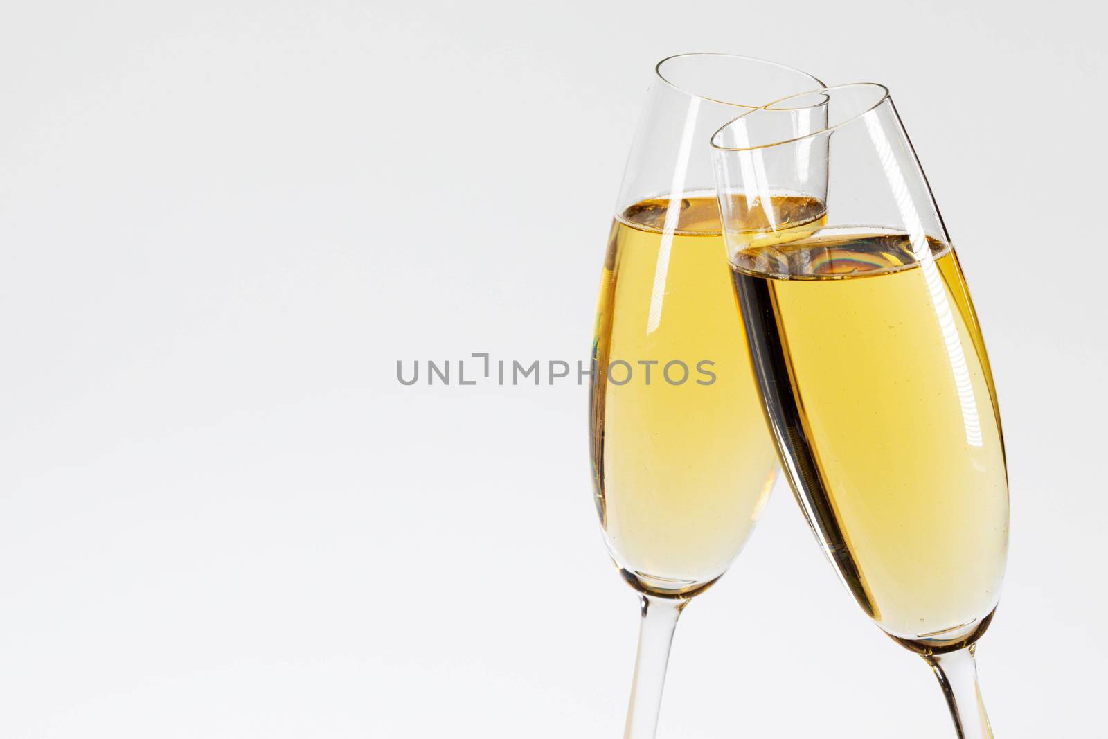 Two glasses of champagne on white background