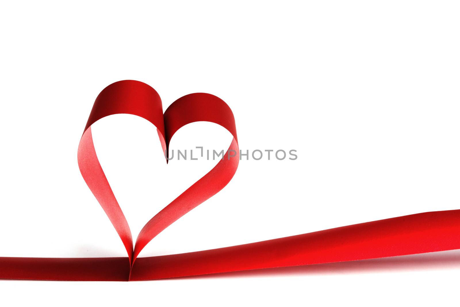 Heart shaped red ribbon isolated on white background