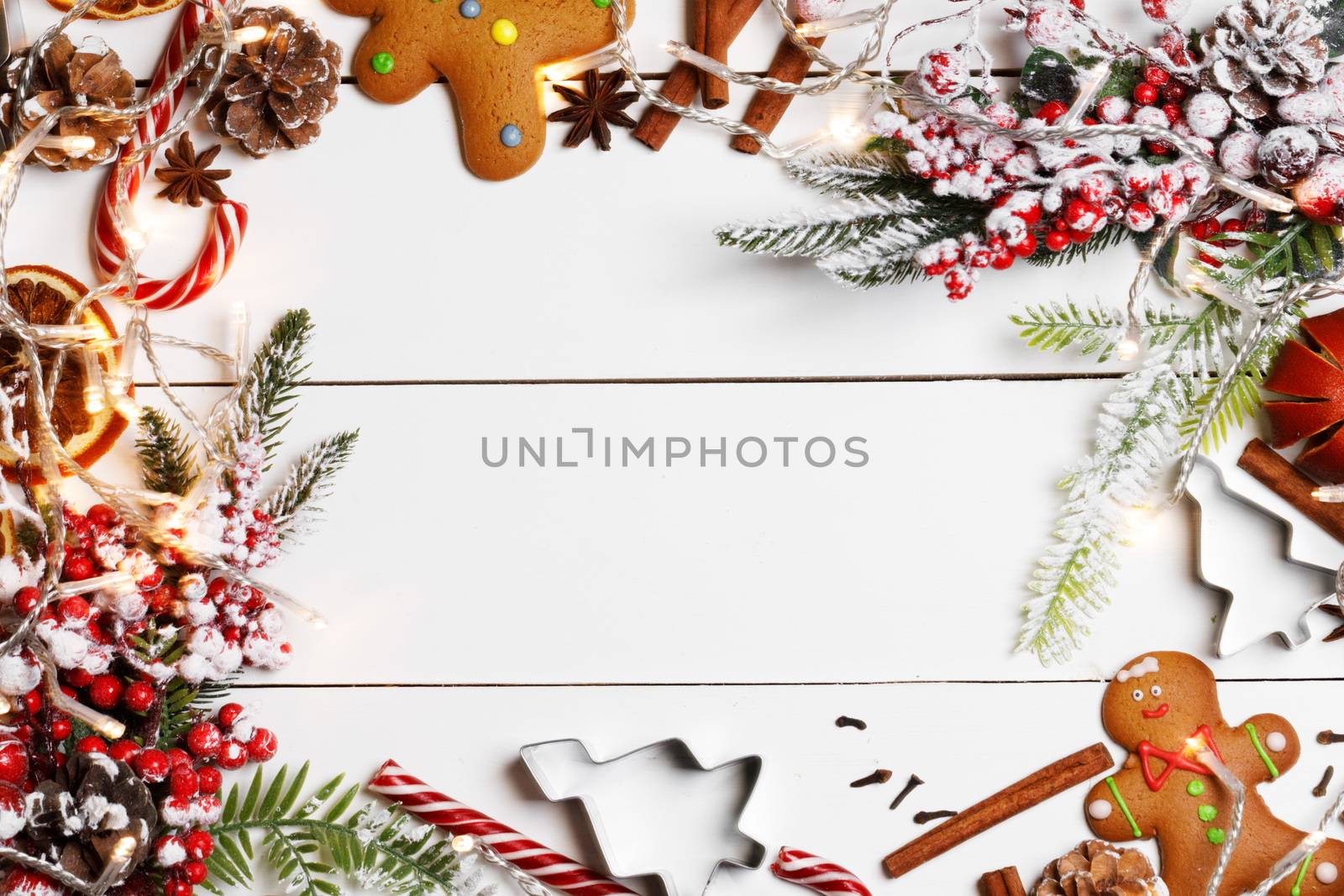 Christmas flat lay background with traditional gingerbread cookies dried orange cinnamon on wood , copy space for text