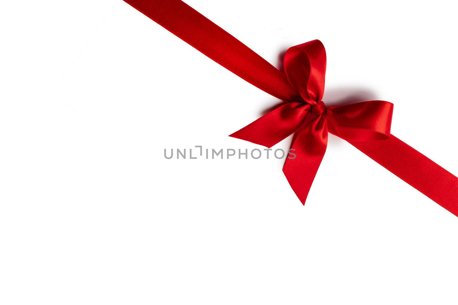 Elegant satin red ribbon bow isolated on white background