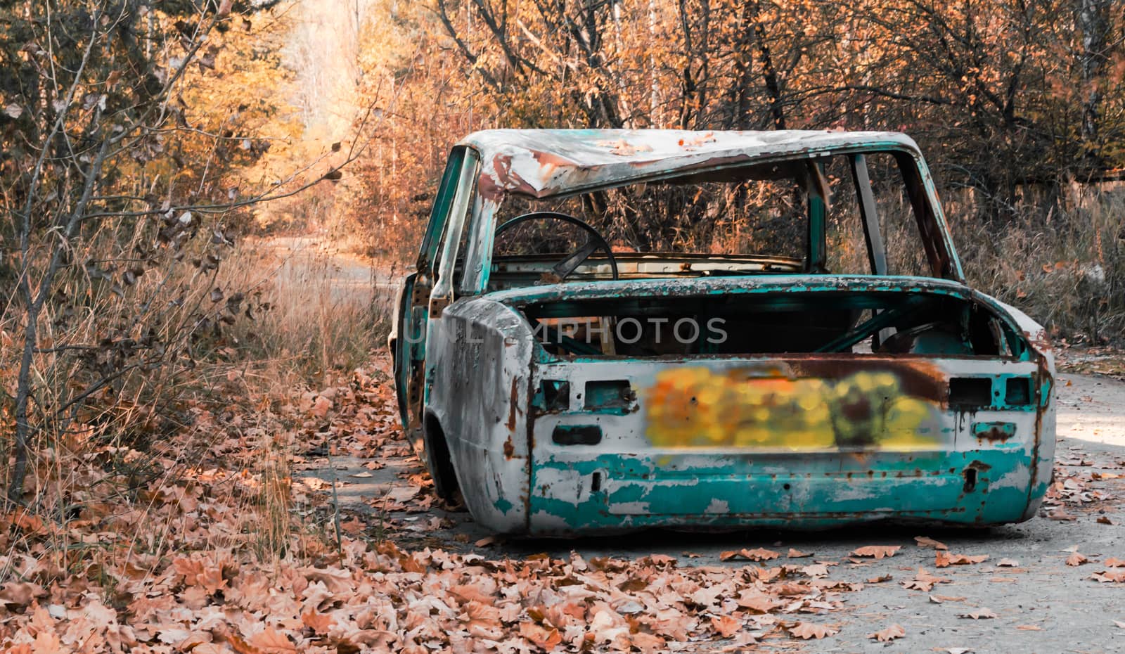 abandoned broken rusty car with no wheels on Chernobyl street