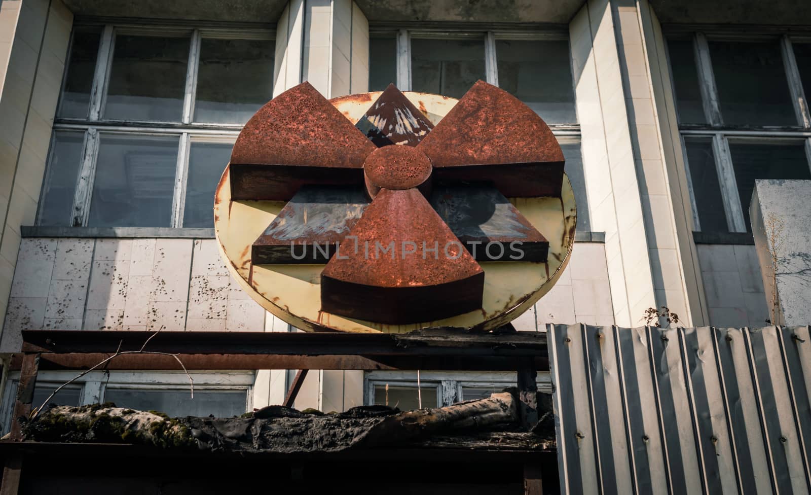 old rusty radioactive symbol on the facade of a building in Chernobyl close up