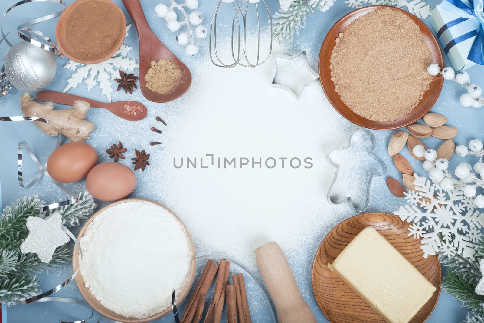 Christmas gingerbread cookies cooking background flat lay top view template with copy space for text. Baking utensils, spices and food ingredients on blue background