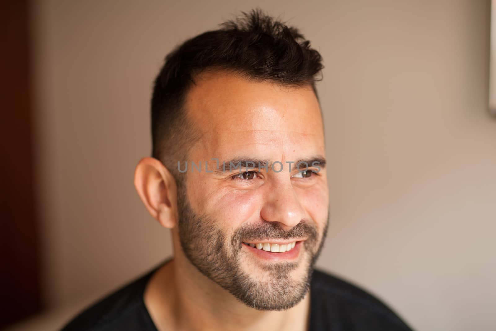 Happy smiling Spanish man indoors