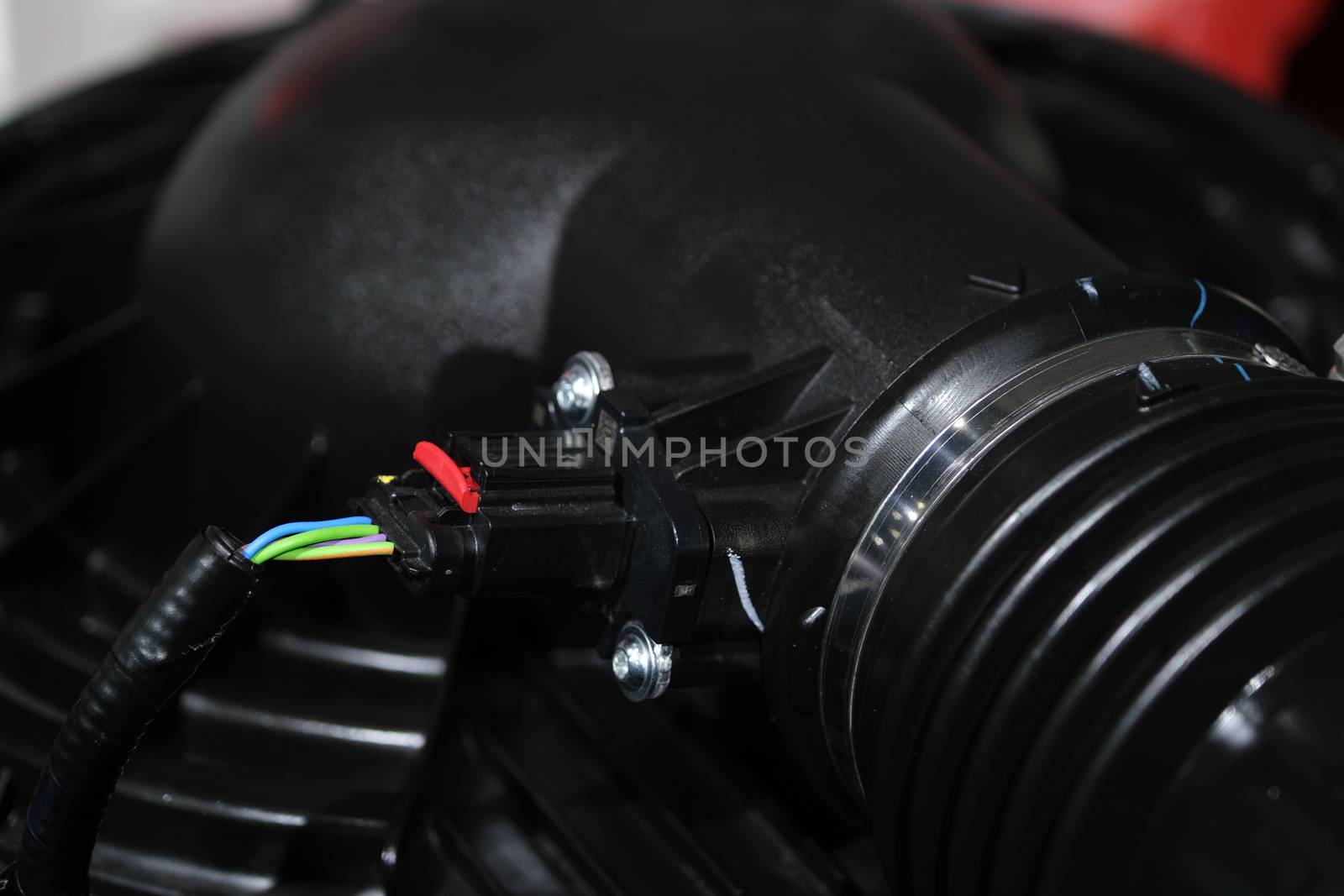 Auto electrician worker is installing a car alarm close up concept. by peerapixs
