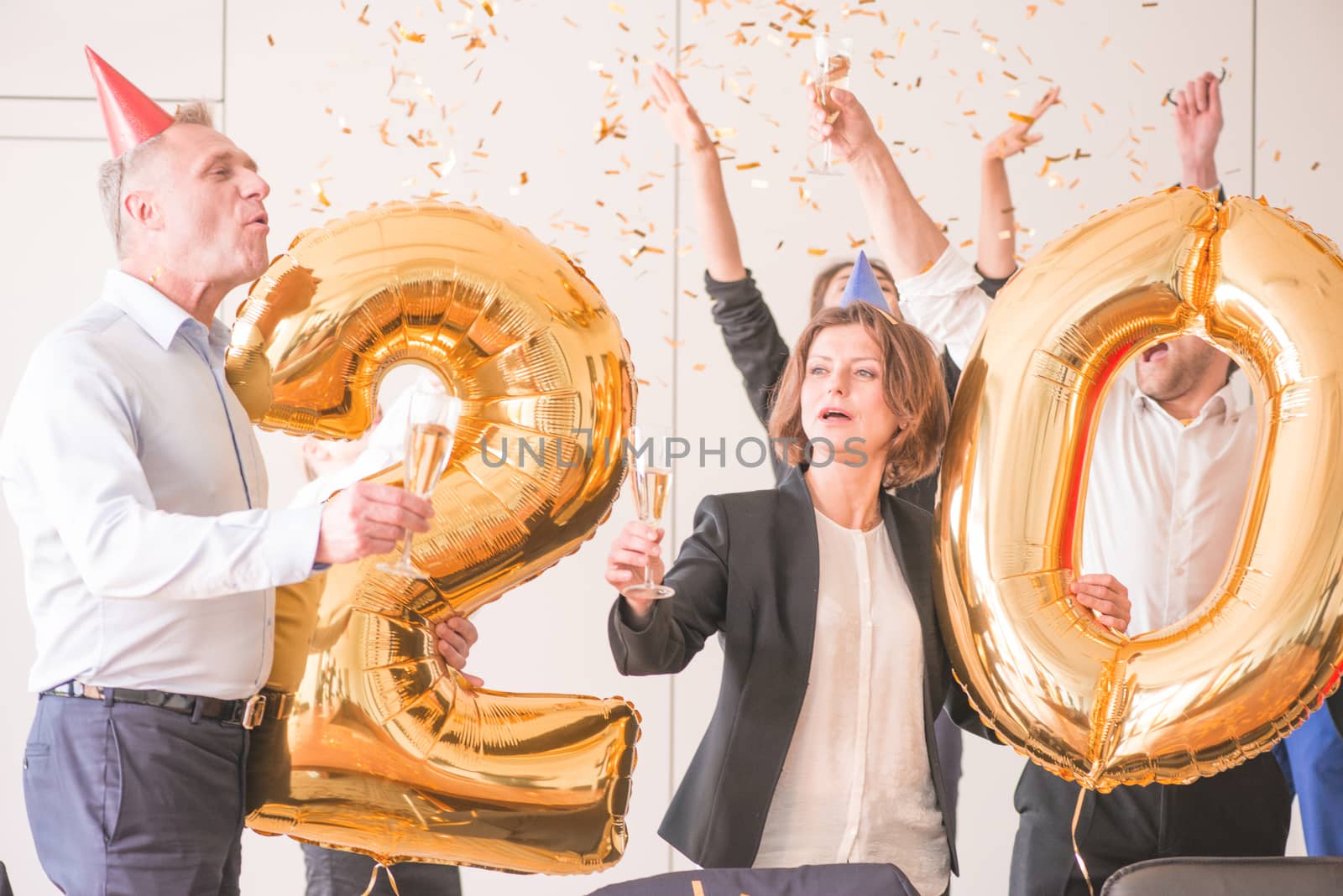 Business team of People Celebrating New Year in Modern Office. People Have Fun. Indoor Party. Celebrating of New Year.
