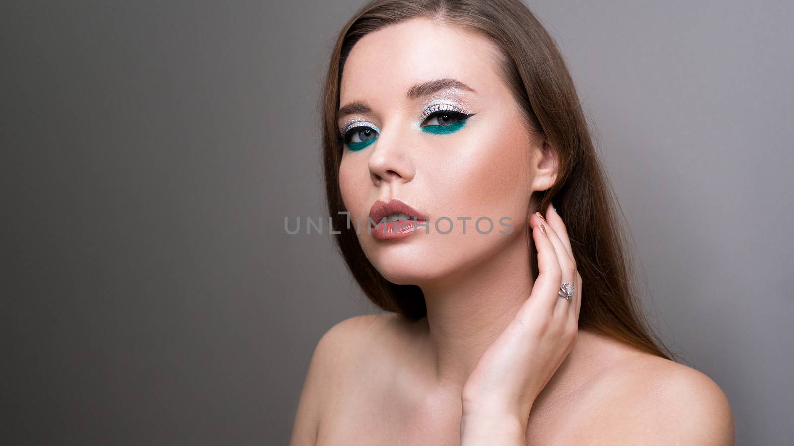 Professional beauty eyes makeup. Make up closeup. Long hair and perfect skin on a gray background