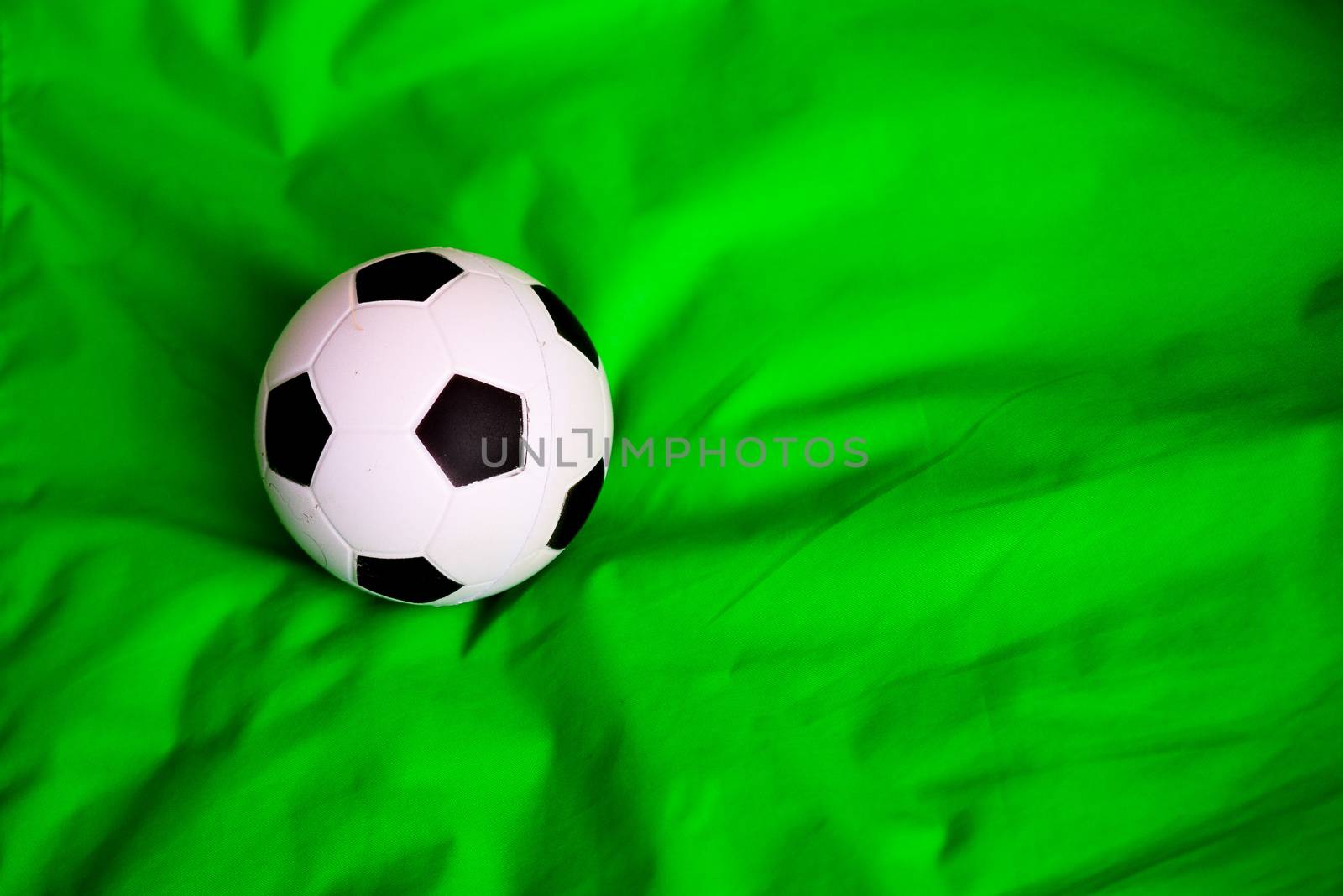 miniature soccer ball on fabric or carpet surface