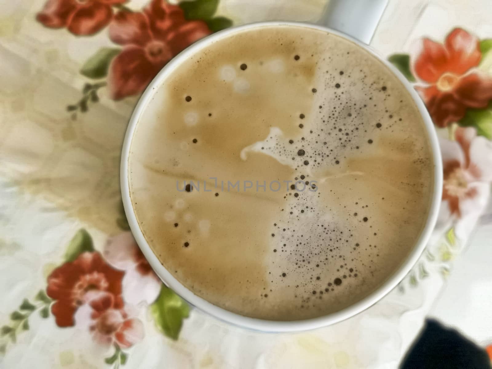 White cup of Cappuccino with foam on kitchen table in the morning . View from top. cappuccino coffee in mug close up. latte drink with froth