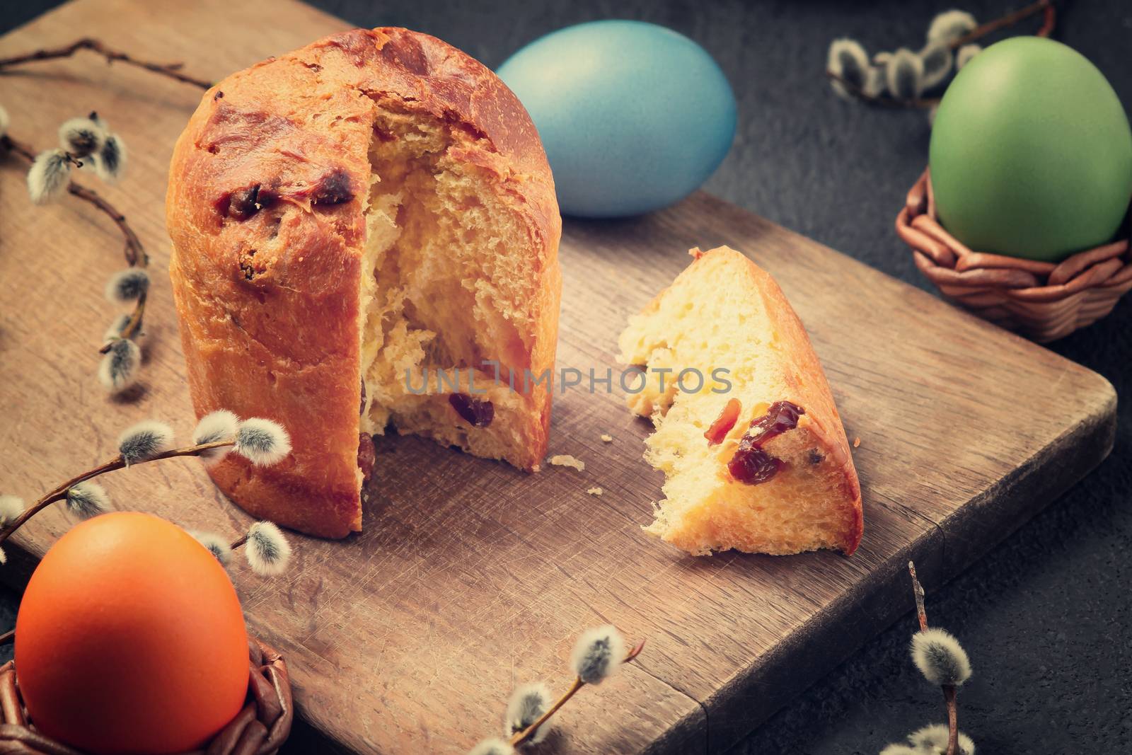 Easter cake on a cutting board and colored eggs - traditional easter breakfast by galsand