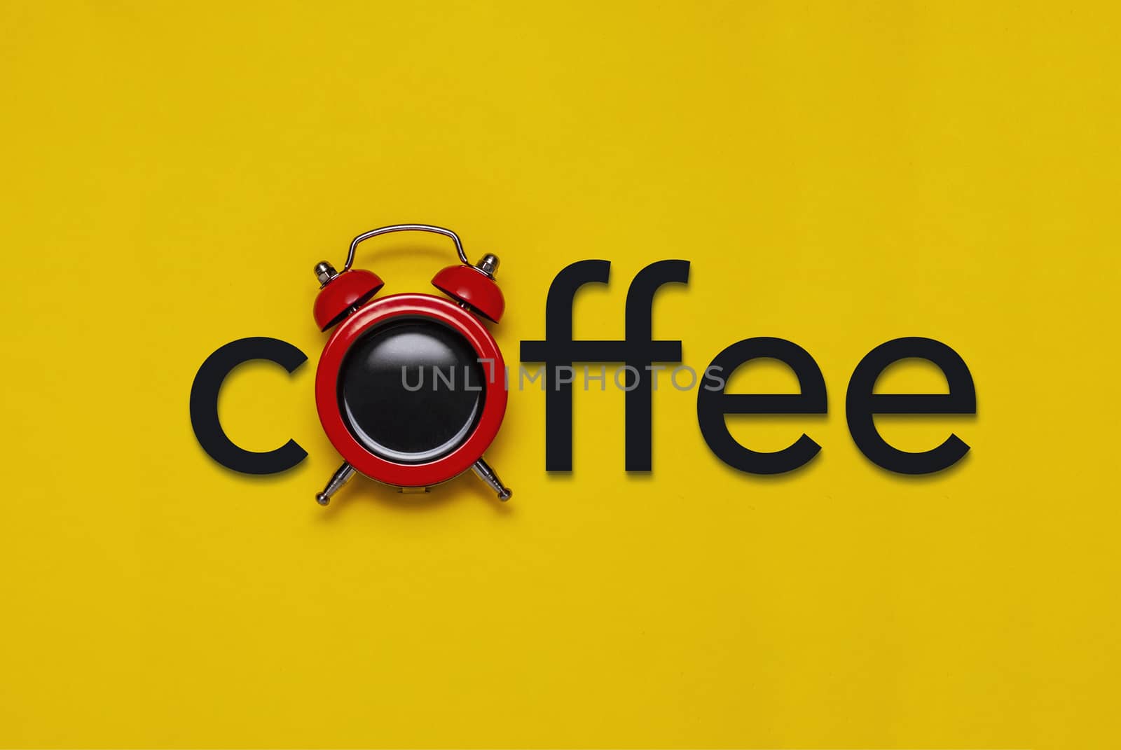 Coffee concept with alarm clock and text over a colourful yellow background conceptual of a countdown to a coffee break