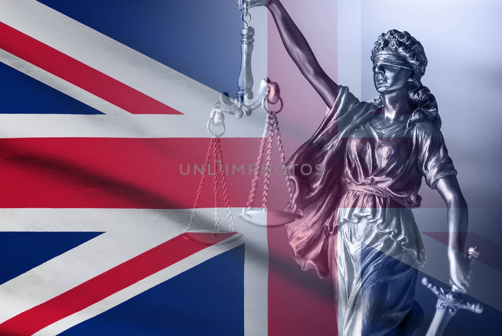 Statue of Justice over a British Union Jack flag holding the scales and sword of law enforcement and justice
