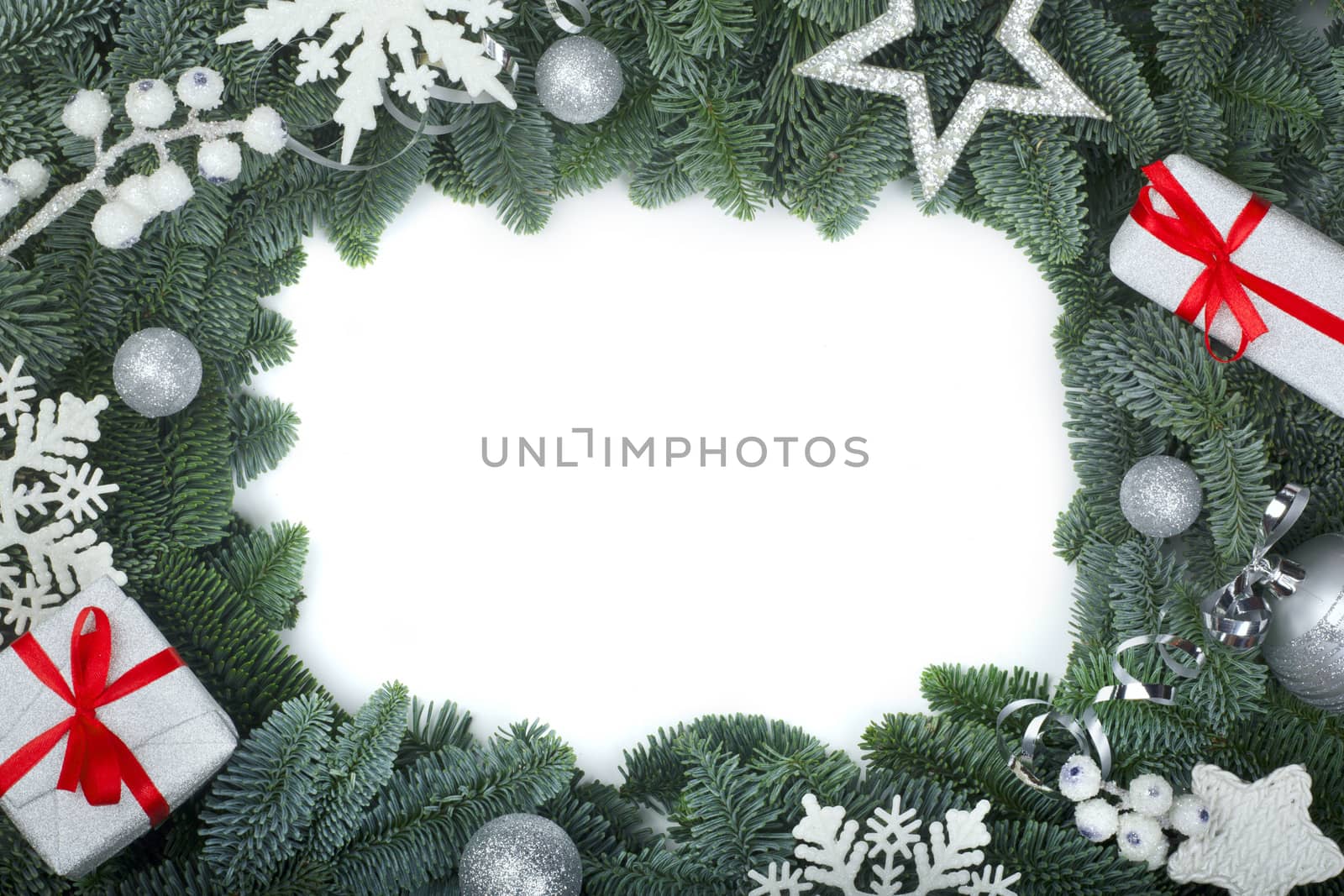 Christmas design boder frame greeting card of noble fir tree branches gifts and silver baubles isolated on white background