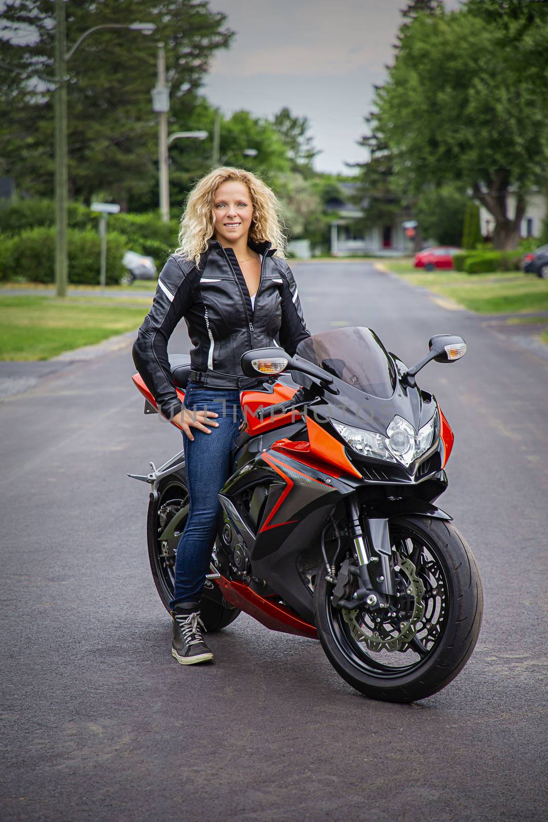 Twenty something blond woman sitting on a sport motocyle