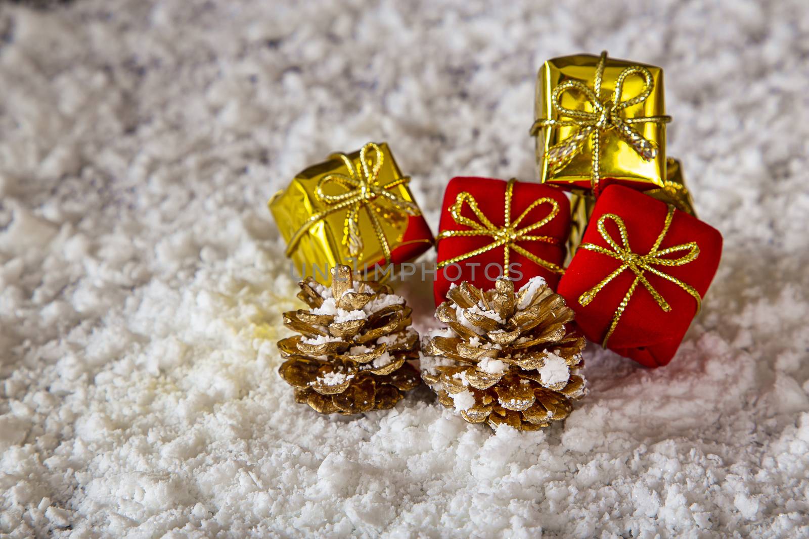 small present and pinecone in the snow