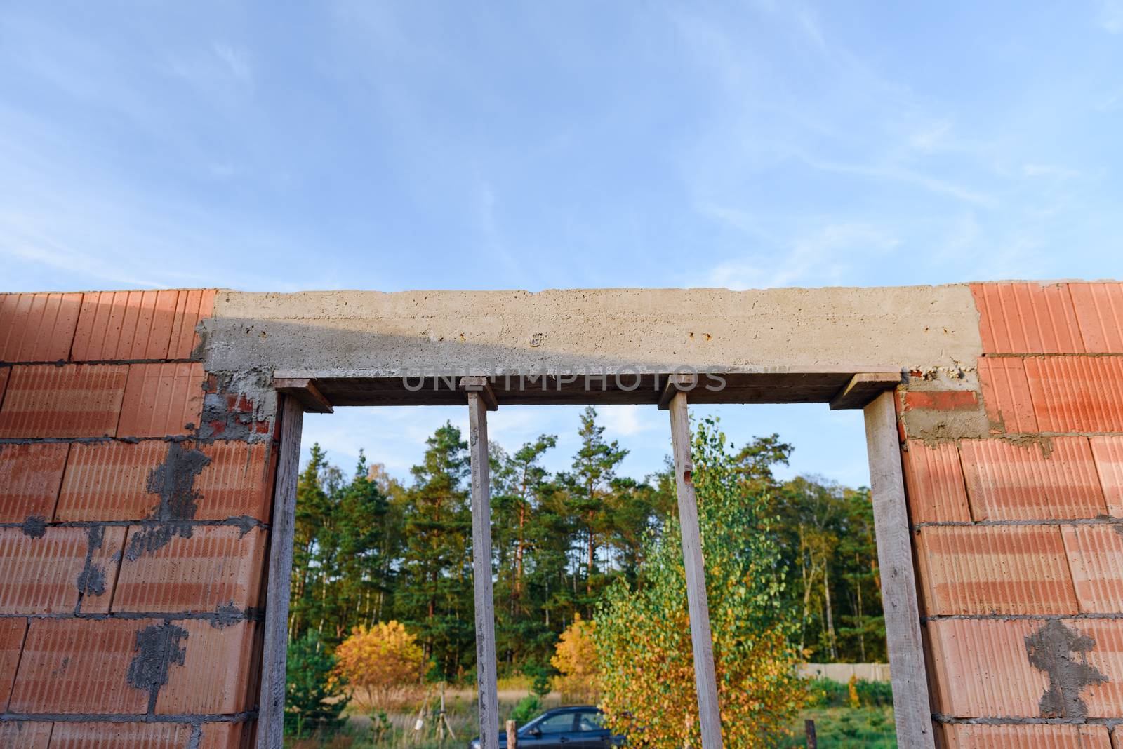 Interior of a Unfinished Red Brick House Walls under Construction without Roofing.