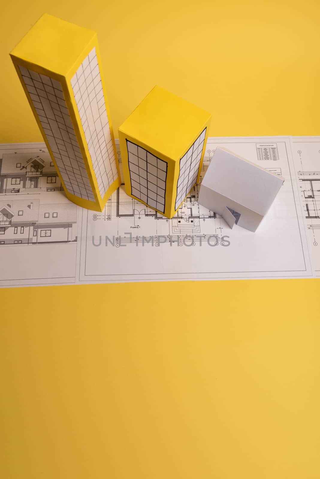 Yellow paper block of flats on yellow background paper. Minimalistic and simple concept, style. Copy space. Horizontal orientation.